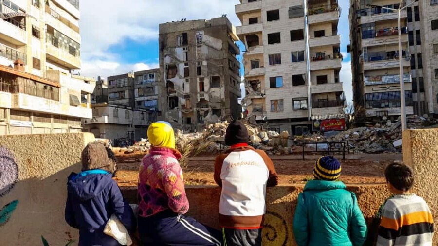 Residents of Syria's Hama Governorate gaze at earthquake-damaged buildings